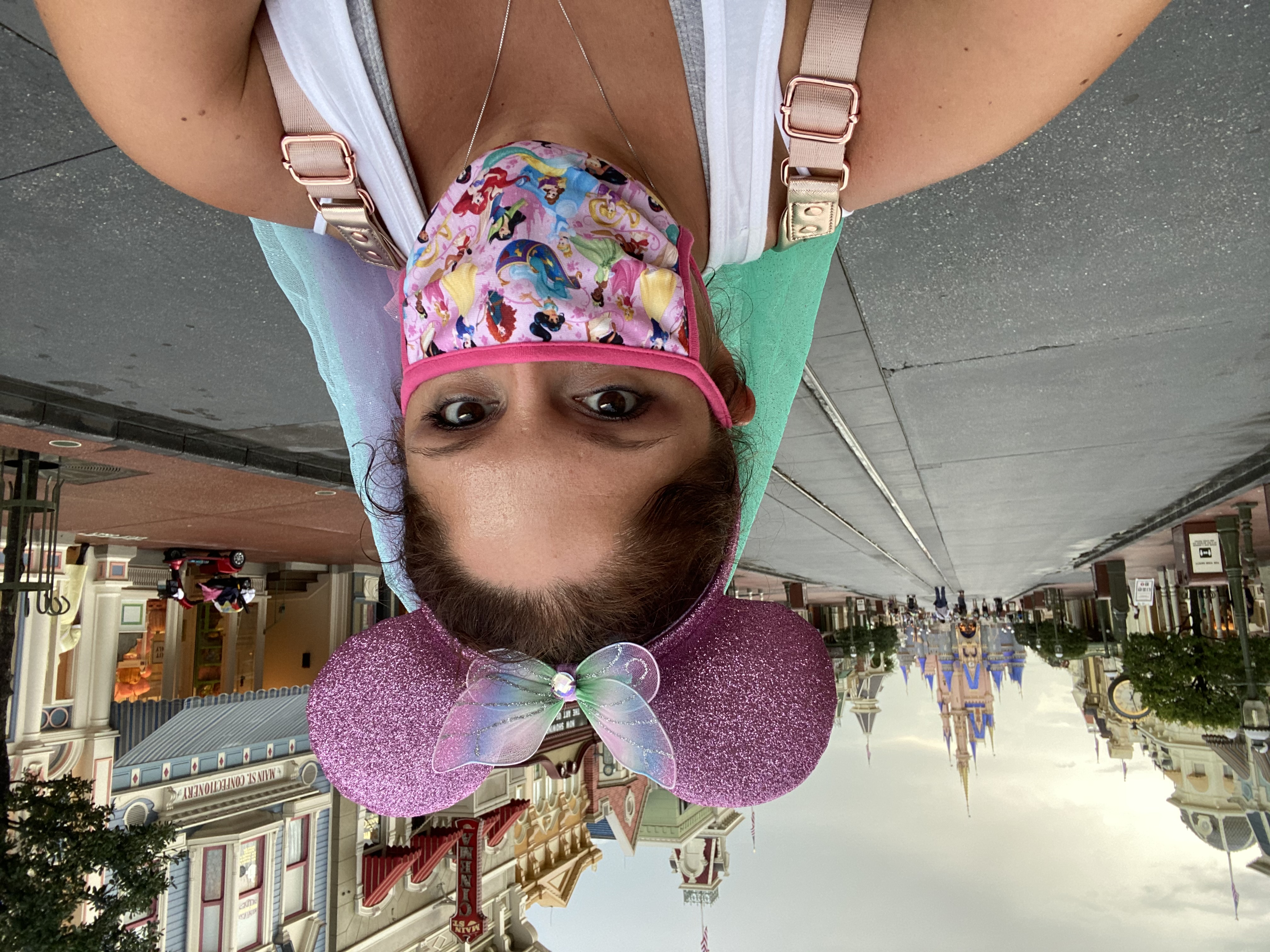 disney magic kingdom selfie in front of the castle and main street usa with mask and mickey ears during pandemic