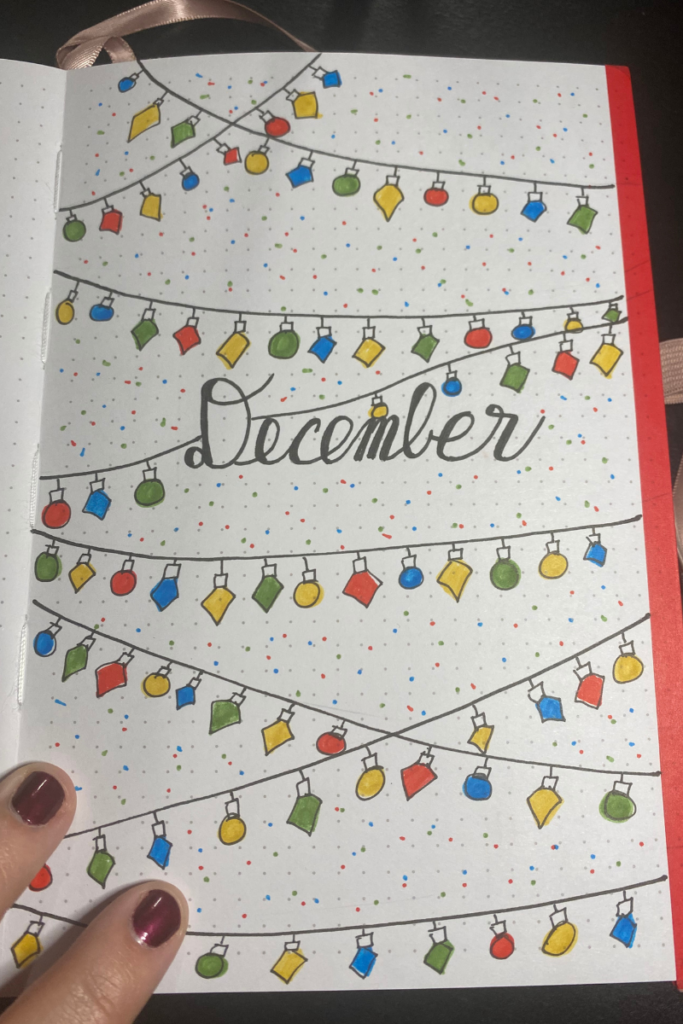 December 2023 Bullet Journal Cover page featuring colorful christmas string lights.