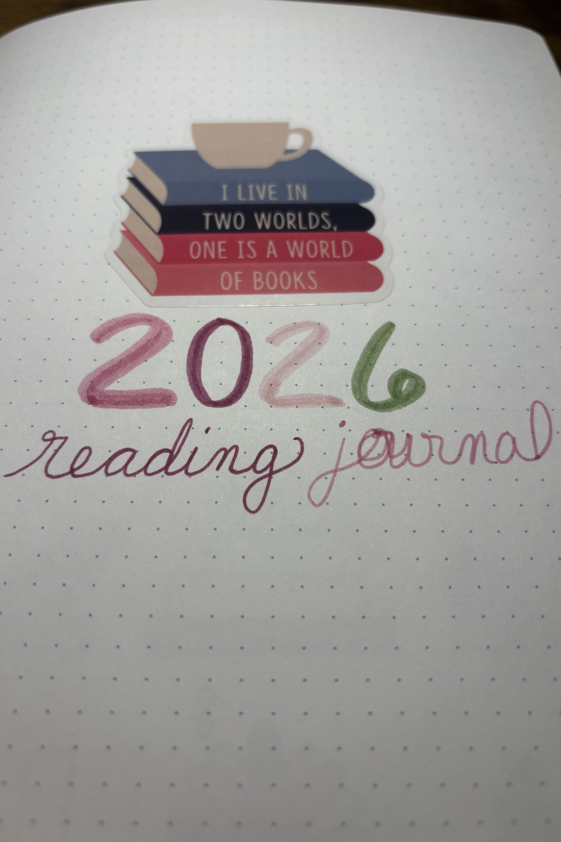 photo of the cover of page for my reading journal featuring a sticker with the gilmore girls quote "I live in two worlds. One is a world of books."